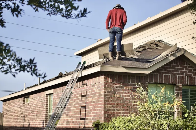 Professional roofer working on a residential roof in North Bergen
